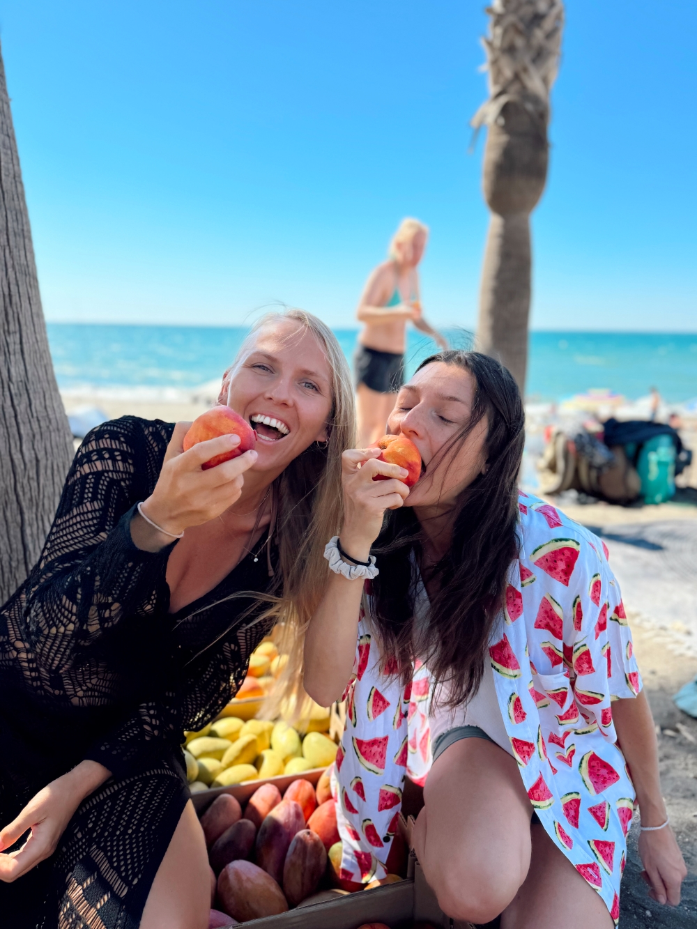 Friends enjoying fruit at the beach