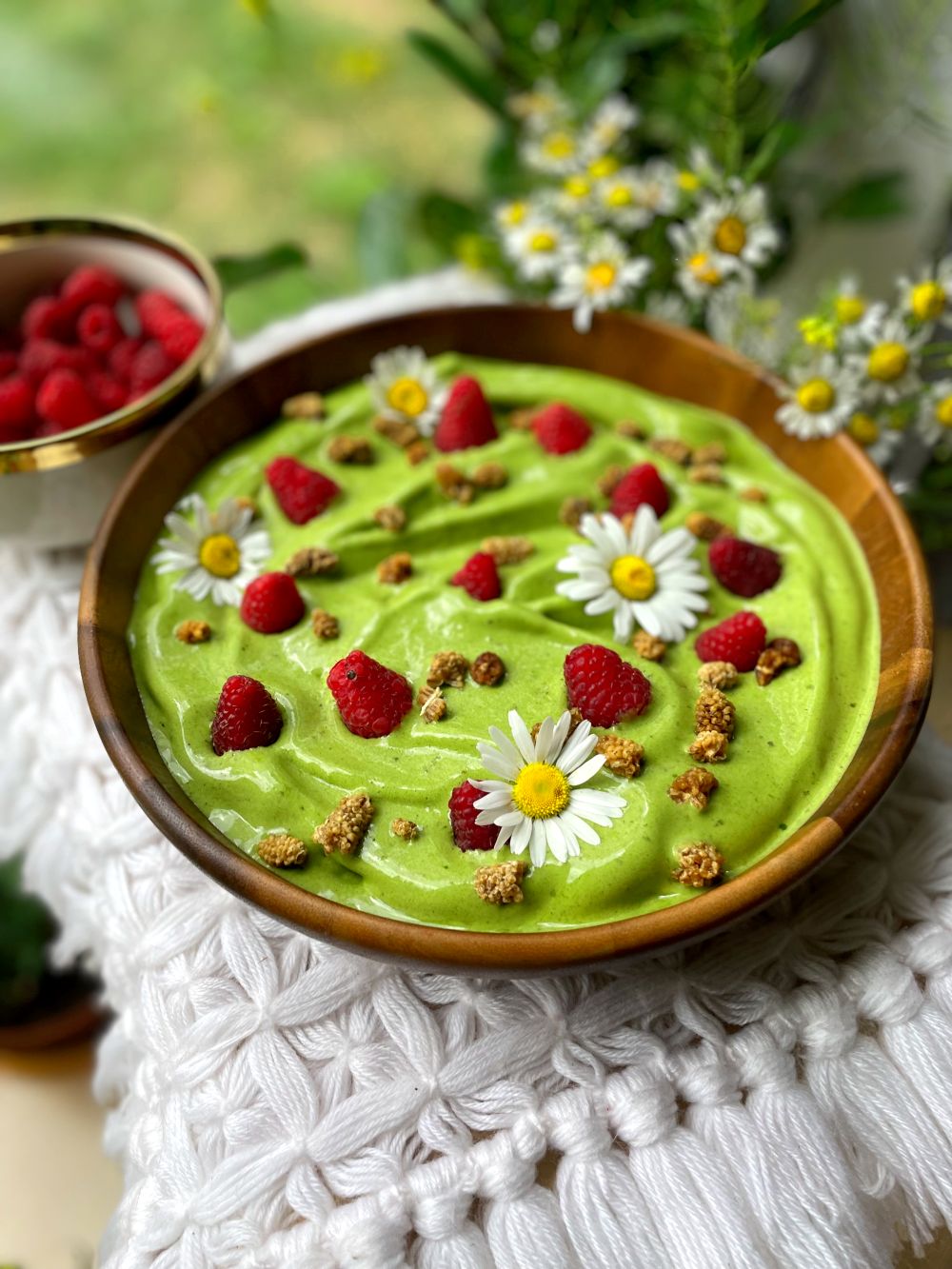 Green smoothie bowl with raspberries